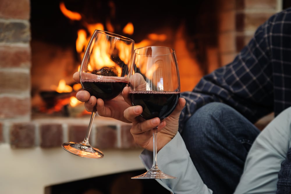 Couple enjoying wine by the fire at our Bed and Breakfast in Durham, NC